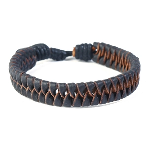 Detailed close-up of hand-woven black and brown cowhide leather braided bracelets