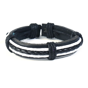 Detail view of multi-layer black and white braided leather bracelet with vintage punk style