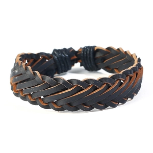 Detail of hand-woven leather bracelet showing black and brown contrast braiding