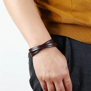 Retro multi-layer dark brown leather wrap bracelet for men on wrist with yellow sweater