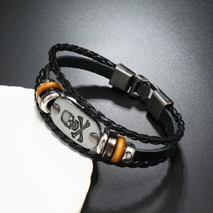 Macro detail of multi-layer leather punk bracelet with skull relief and metal clasp