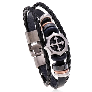 Close-up of multilayer leather bracelet with braided cord and silver star detail