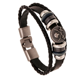Macro detail of multi-layer leather bracelet with pirate skull crest and metal buckle