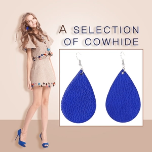 Detail view of dark blue teardrop leather earrings with textured cowhide finish for women