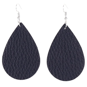 Detailed view of black teardrop earrings with textured faux leather and silver hooks