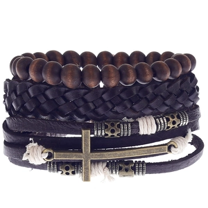 Detail view of multilayer leather bracelet with wooden beads and bronze cross charm