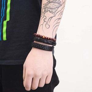 Three-piece men's bracelet set with brown wood beads and black braided leather layers