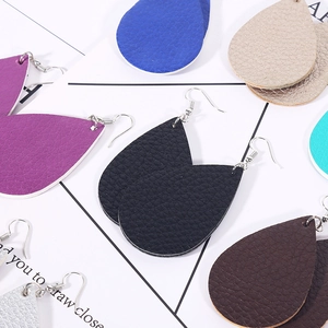 Detail of layered teardrop leather earrings featuring litchi texture in multiple colors