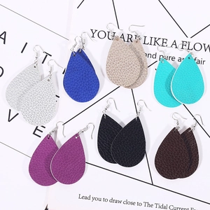 Seven pairs of colorful teardrop faux leather earrings with litchi texture on white board