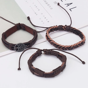 Detail view of vintage multi-layer braided leather bracelets with tree of life metal charm