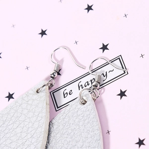 Silver teardrop earrings with lychee texture on pink background and star decor