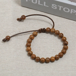 Detailed view of adjustable chicken wing wood bead bracelet with natural grain texture