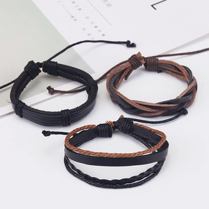 Detail view of a 3-piece set featuring braided leather and wax cord bracelets for men