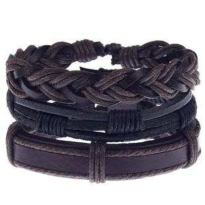 Detailed view of layered men's braided leather bracelets in dark brown and black