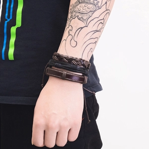 Close-up of vintage multi-layer braided leather bracelets with alloy anchor charms for men