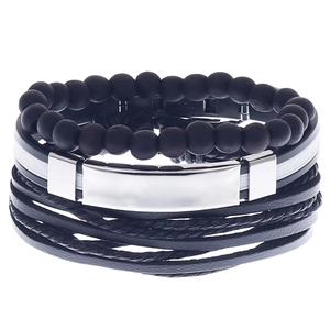 Detail view of multi-layer black men's bracelet with matte beads and silver metal plate