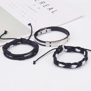 Close-up of three-piece men's bracelet set with woven leather and metallic accents
