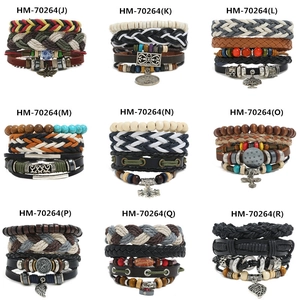 Detailed close-up of multi-layer braided leather bracelets with diverse alloy charms