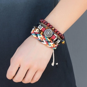 Detail of bohemian layered bracelet set with wood beads and ethnic braided cords