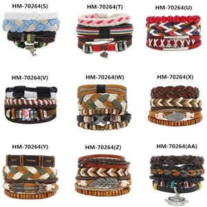 Macro detail of multilayer woven leather bracelets with wooden beads and metal feather charms