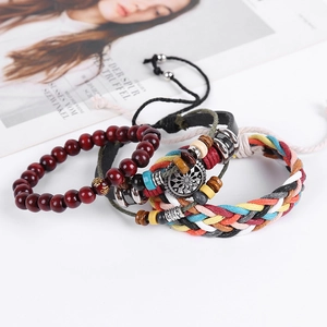 Detailed view of bohemian braided rope bracelets with wood beads and sun charm