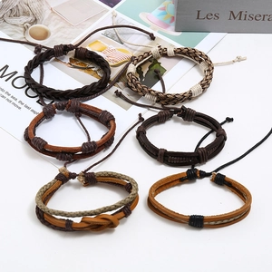 Detailed view of six vintage braided leather bracelets in brown and black tones