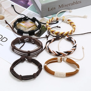 Detail of six handmade vintage woven leather bracelets in black and brown tones