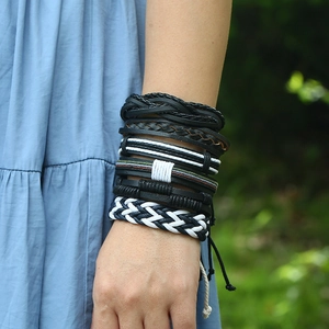 Close-up of a 6-piece men's braided leather bracelet set worn on a model's wrist