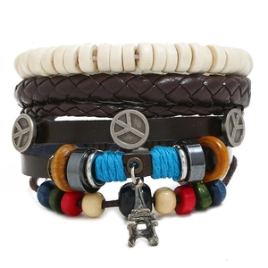 Detailed macro view of multilayer leather bracelet with Eiffel Tower charm and peace symbols