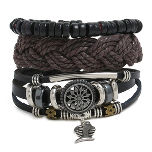 Detail of layered leather bracelets featuring sunflower emblem and fishbone charm