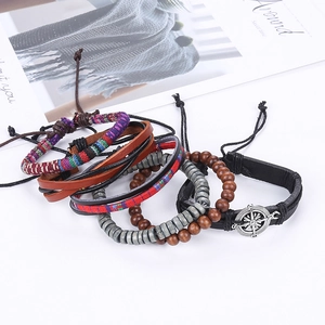 Bohemian multilayer leather bracelet set with wooden beads and compass charm on white background