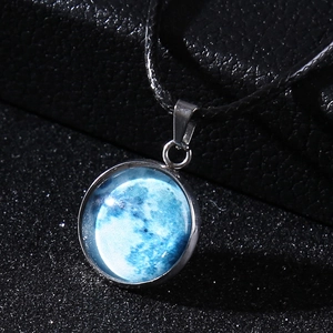 Detail of moon pendant with blue surface texture and black wax rope necklace