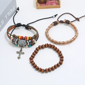 Detail shot of multi-layer leather bracelets set with metal charms and wooden beads