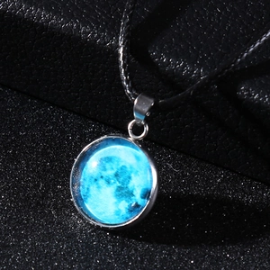 Close-up of blue moon glass pendant necklace with intricate lunar texture on dark leather