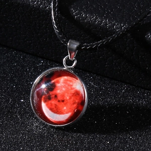 Detailed view of galaxy moon pendant necklace with red lunar glass gem and wax rope cord