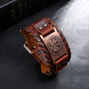 Detail of vintage braided leather bracelet with copper tree of life and pentagram plaque