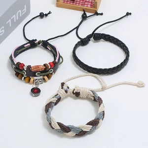 Detail of three-piece layered leather bracelet set with wooden beads and woven ropes