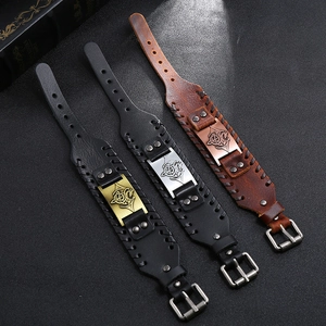 Close-up of vintage braided leather bracelets with Viking dragon motif alloy plates