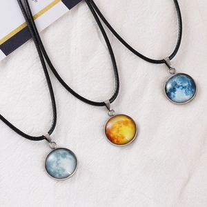 Detail showing three moon pendant necklaces with celestial glass gems on black rope cord