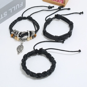 Detailed close-up of a 3-piece vintage black leather bracelet set with alloy leaf charm