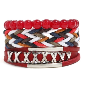 Close-up of layered leather bracelet with red beads and silver metal X-shaped ornaments
