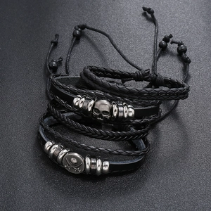 Men's vintage black leather bracelet set with skull charms and braided punk designs