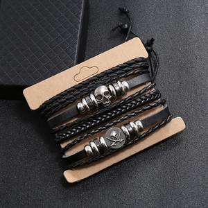 Men's multilayer leather bracelet set with vintage skull and pirate charms on display card