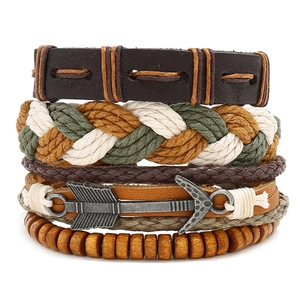 Detail of multi-layer braided leather bracelets with metal arrow and wooden beads