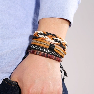 Detail of multi-layer leather bracelets with woven patterns and adjustable pull cord