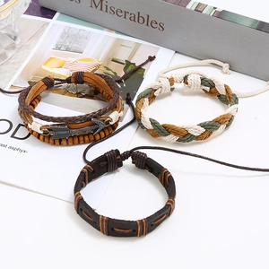 Detail of multi-layer braided leather bracelet set with arrow charm and wooden beads
