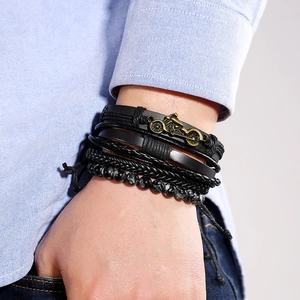 Men's retro layered black leather bracelet set with woven straps and metal motorcycle charm