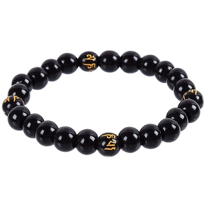 Detailed close-up of black beads with golden Mantra engravings on this spiritual bracelet