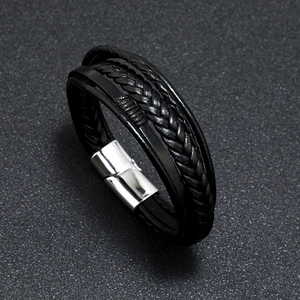Detailed close-up of multilayer braided leather bracelet with silver magnetic metal clasp