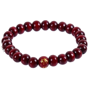 Ethnic style dark red wooden bead bracelet with a golden Buddhist character on a white background